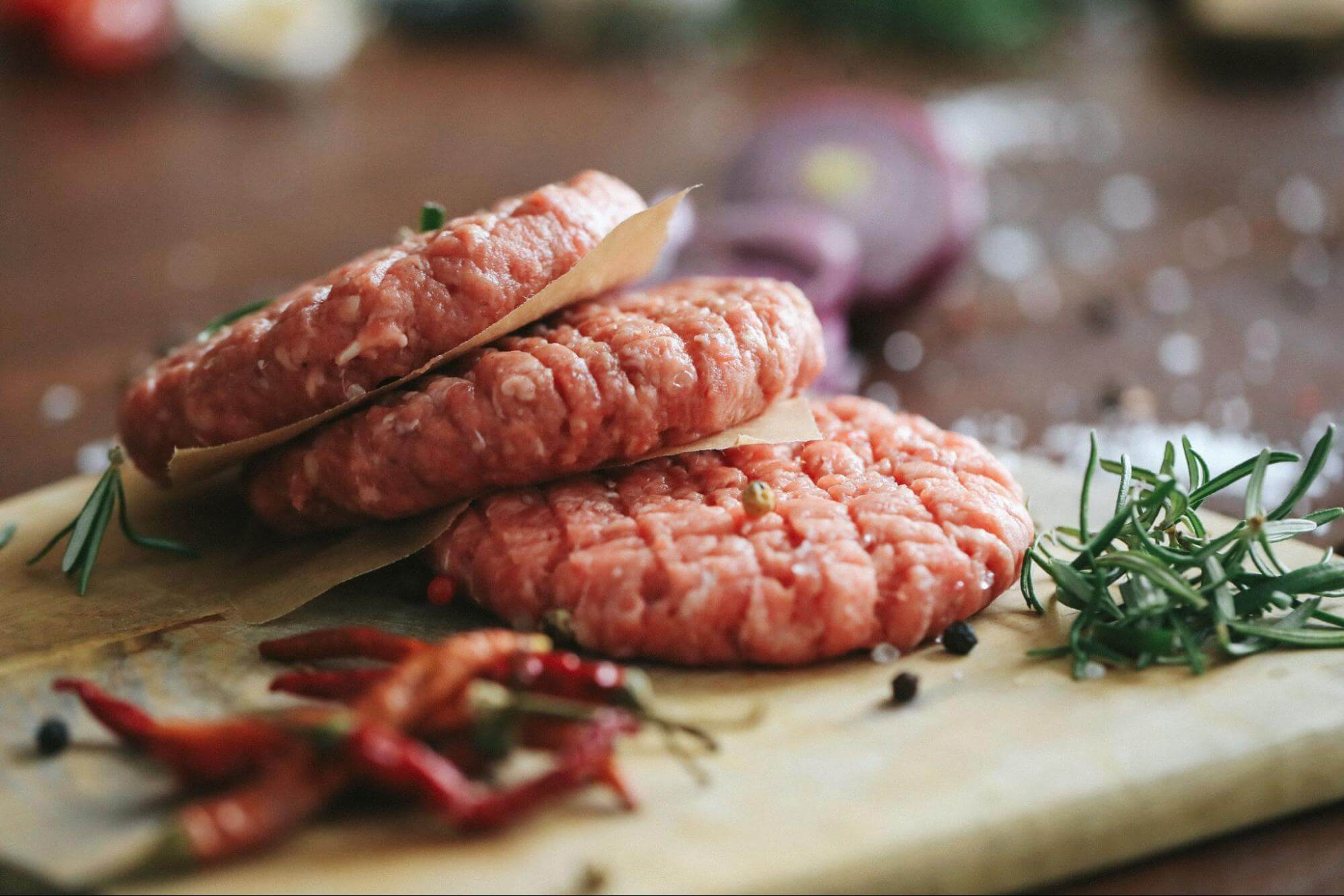 Fresh burger patties, seasoned and ready to grill