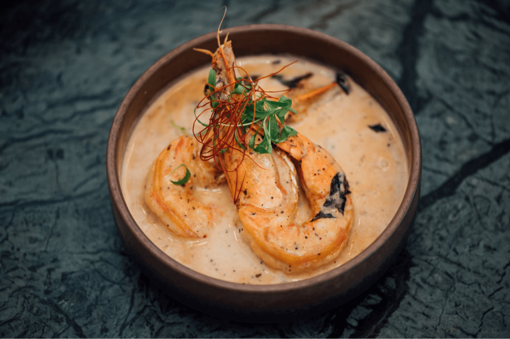 Close-up of a bowl of shrimp bisque soup.